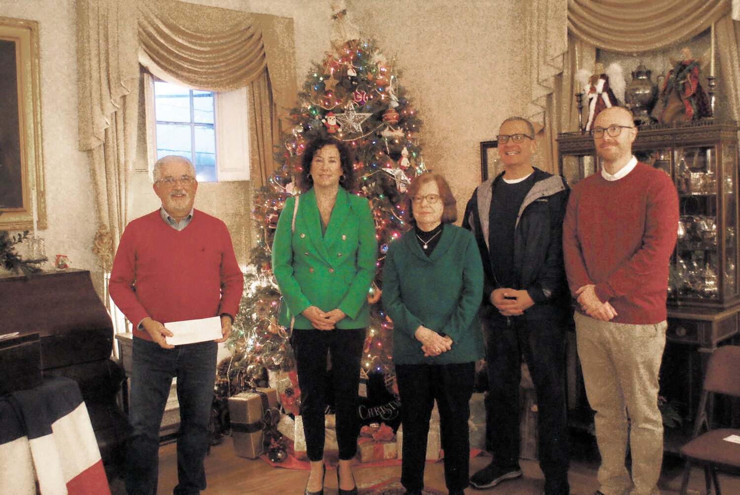 THE SEASON OF GIVING: Director of Community Development Ernest Tommasiello along with City councilors Jessica Marino, Robert Ferri, and John Donegan present Sandra Moyer with a gift from City Hall.